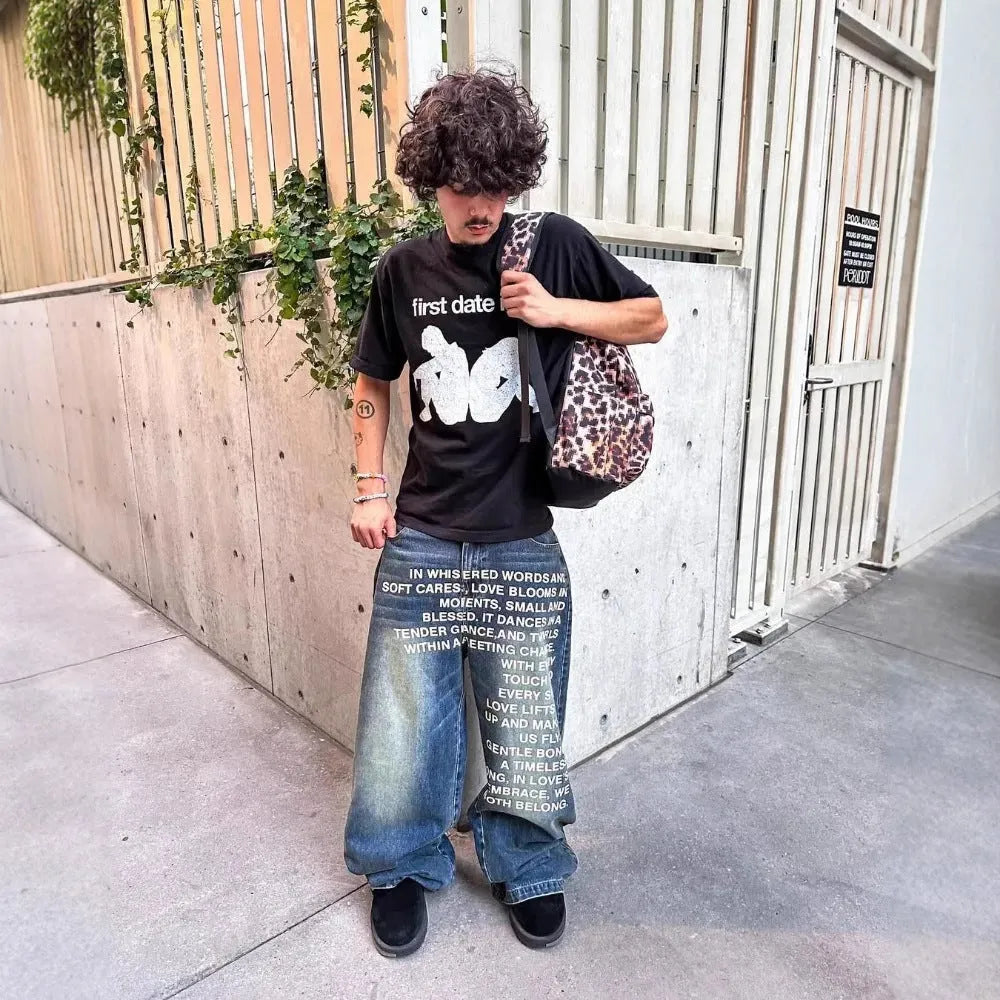 Men's black cotton wide-leg straight trousers with elastic waistband showing loose fit design