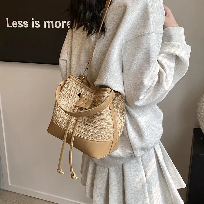 Woven straw women's crossbody bucket bag in horizontal square shape with adjustable shoulder strap