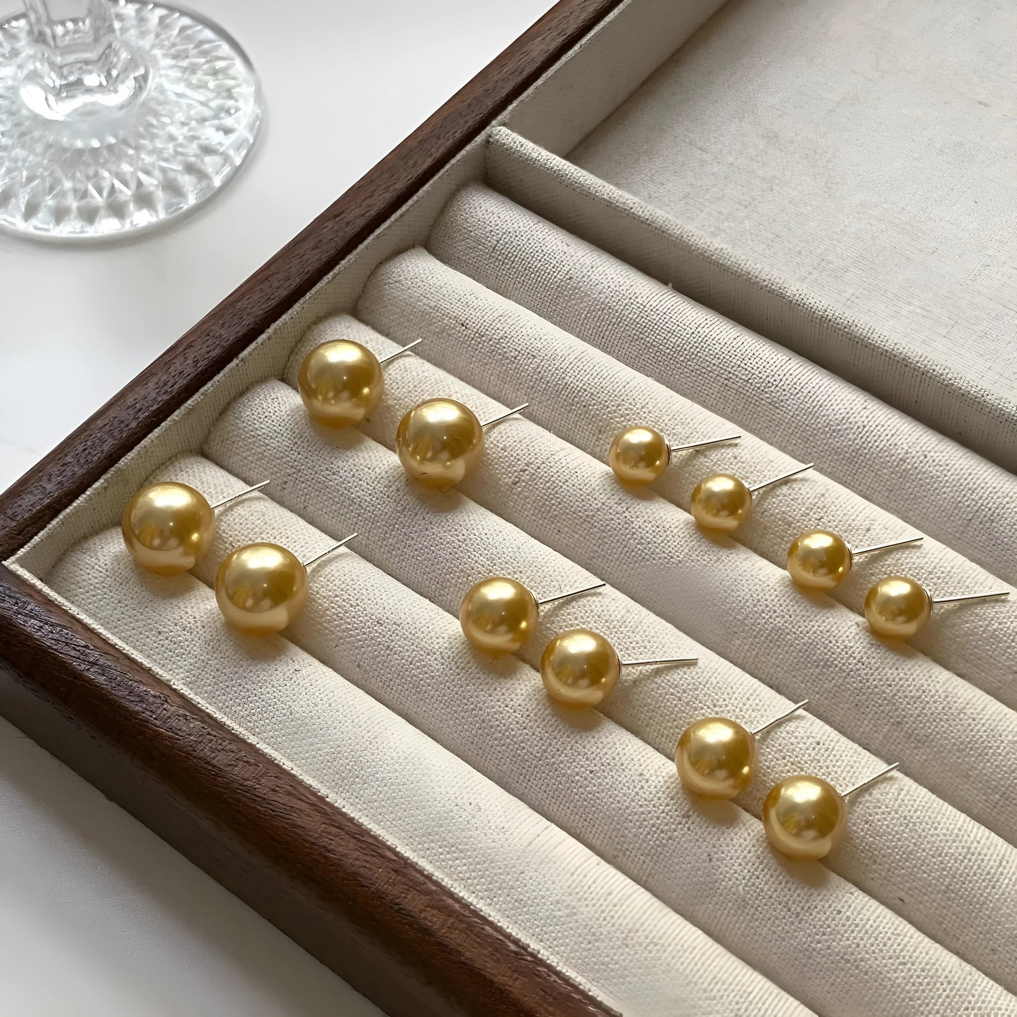 Large pearl stud earrings with geometric silver settings and eight-pointed star motifs