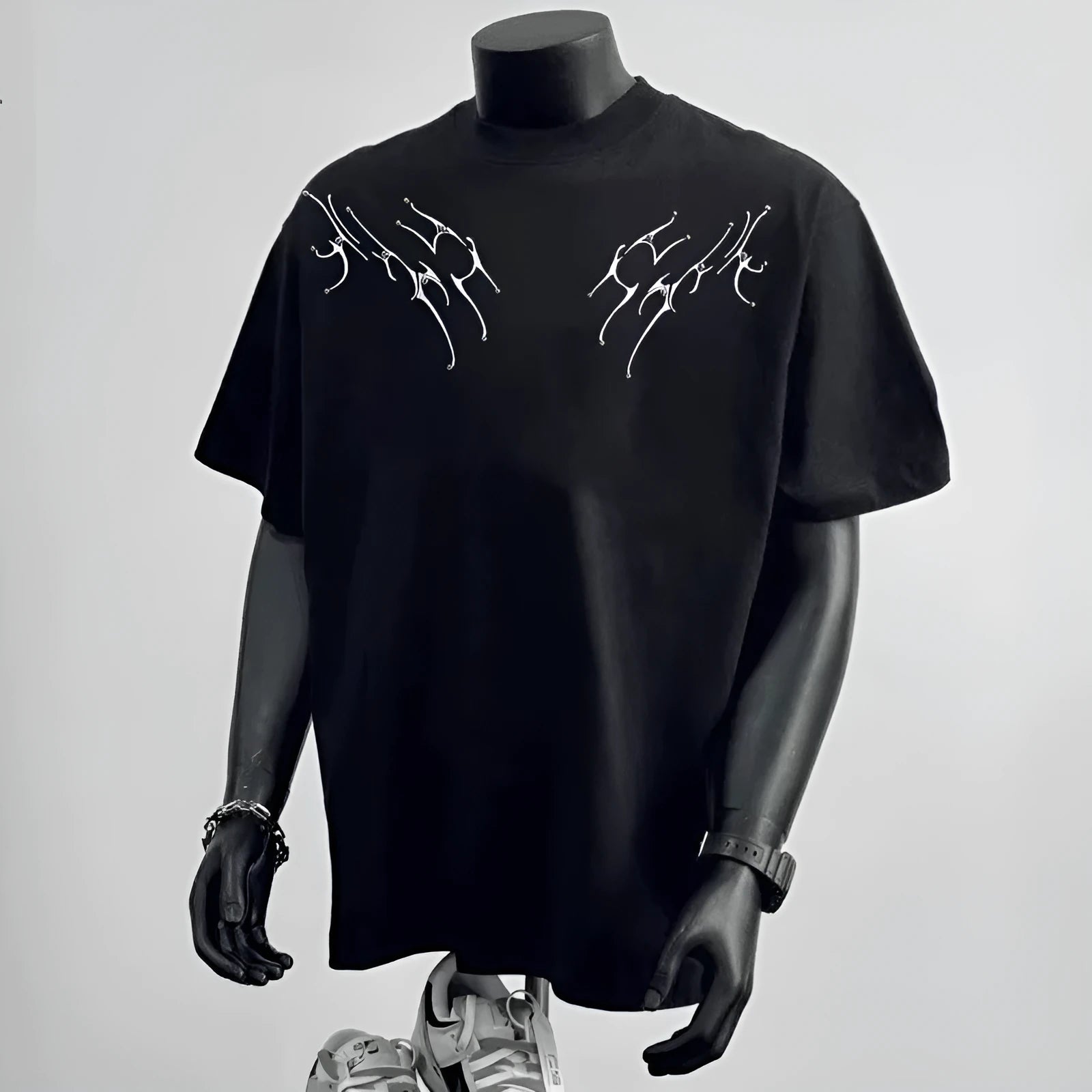 Man wearing a black loose-fit pure cotton short sleeve t-shirt with a printed design.