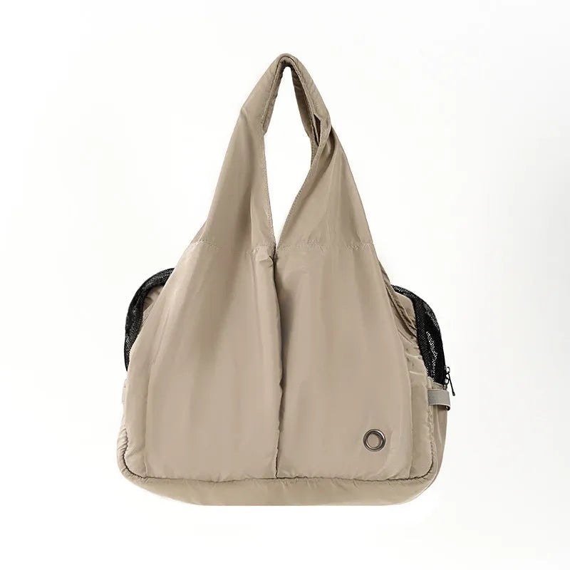 Apricot coloured cloth pet carrier handbag showing portable size.
