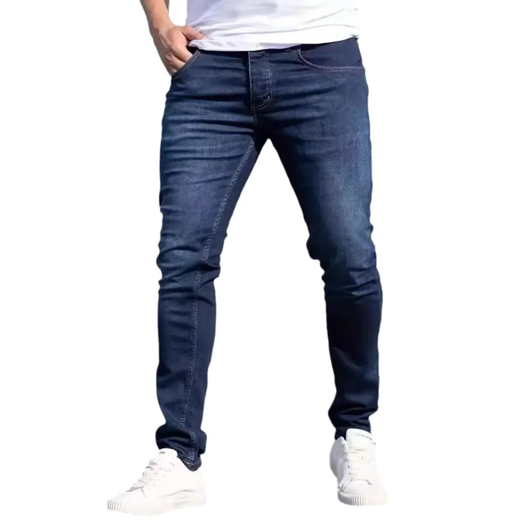 Men's slim-fit dark blue casual jeans with a worn wash and medium elastic cotton fabric.