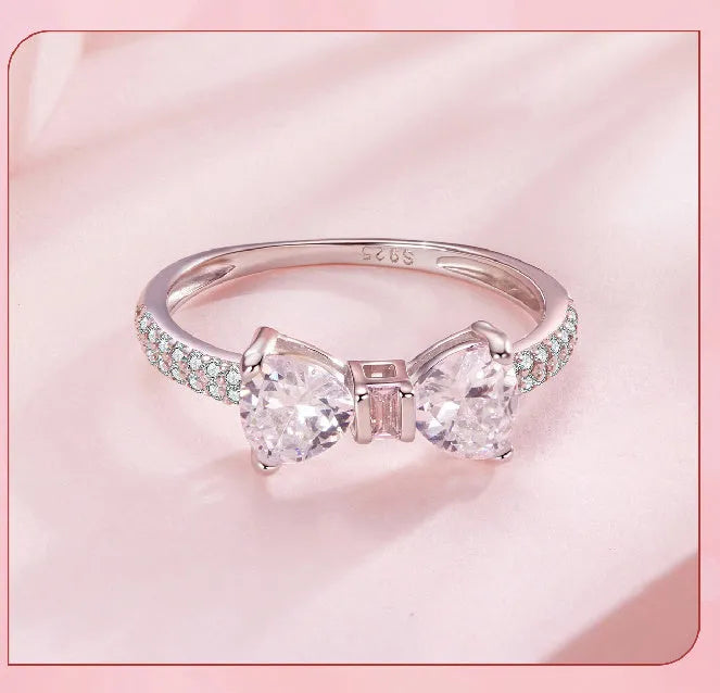 Sterling silver bow ring with zircon stone, available in sizes 6, 7, and 8, electroplated finish