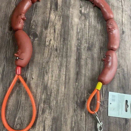 Brown sausage chew toy sewn into a 108cm soft rope dog lead with a grip tape section.