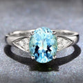 Women's court-style ring with natural zircon inlay in heart, drop, or bell patterns on a blue background.