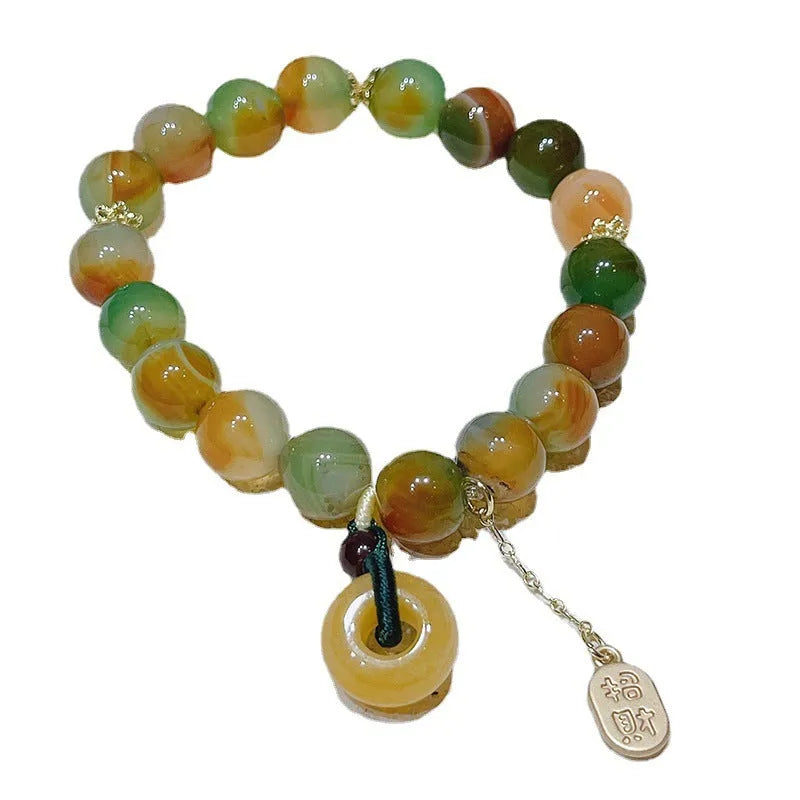 Yellow gold tone peacock agate and old mine topaz bracelet with peace buckle closure
