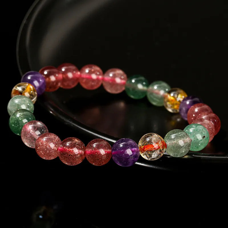 Women's strawberry quartz gemstone bracelet with round beads in a geometric pattern.