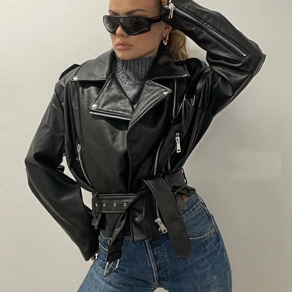Black punk-style leather jacket with a Peter Pan collar, short belt on lapel, and a drawstring waist.