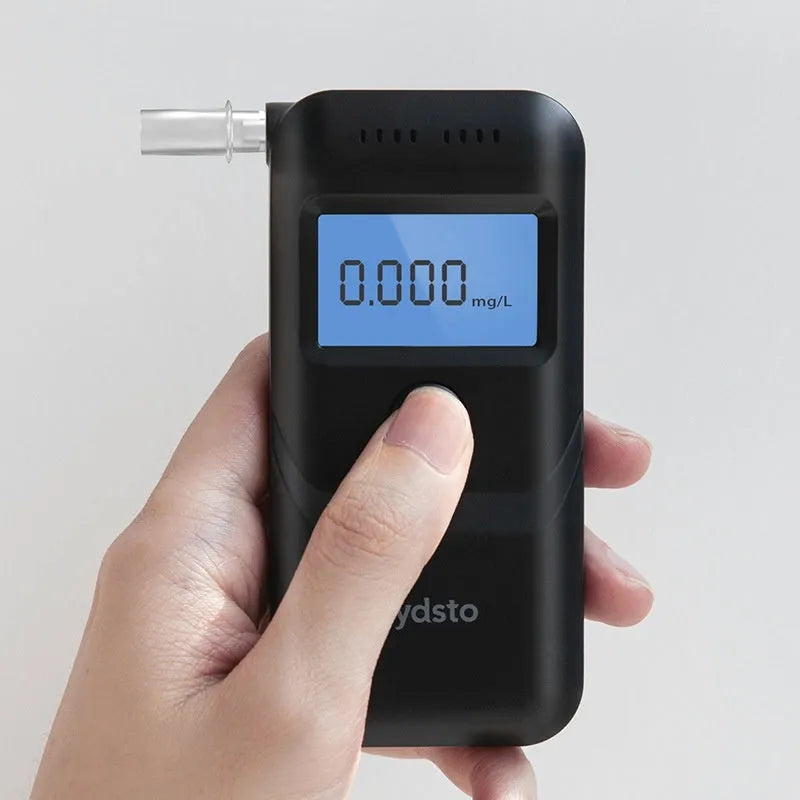Black household personal alcohol breath tester unit on a white background.