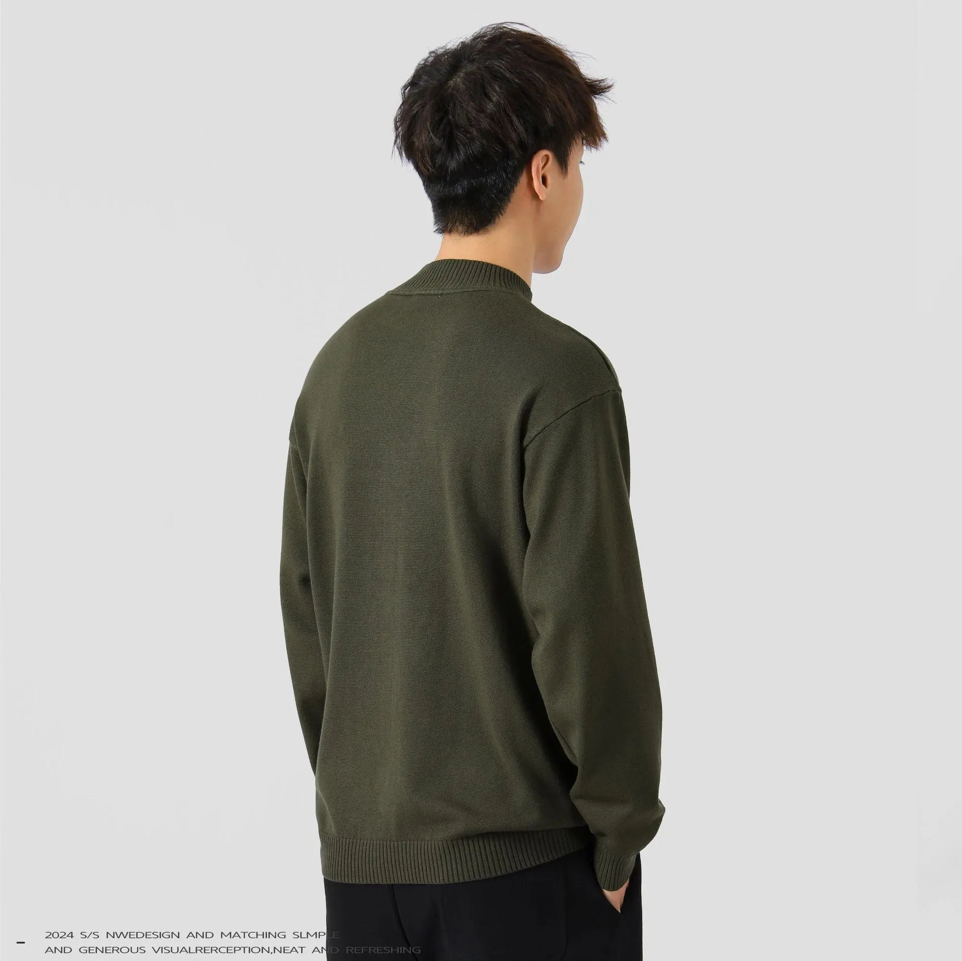 Men's loose fit long sleeve casual jumper in army green colour on a hanger.