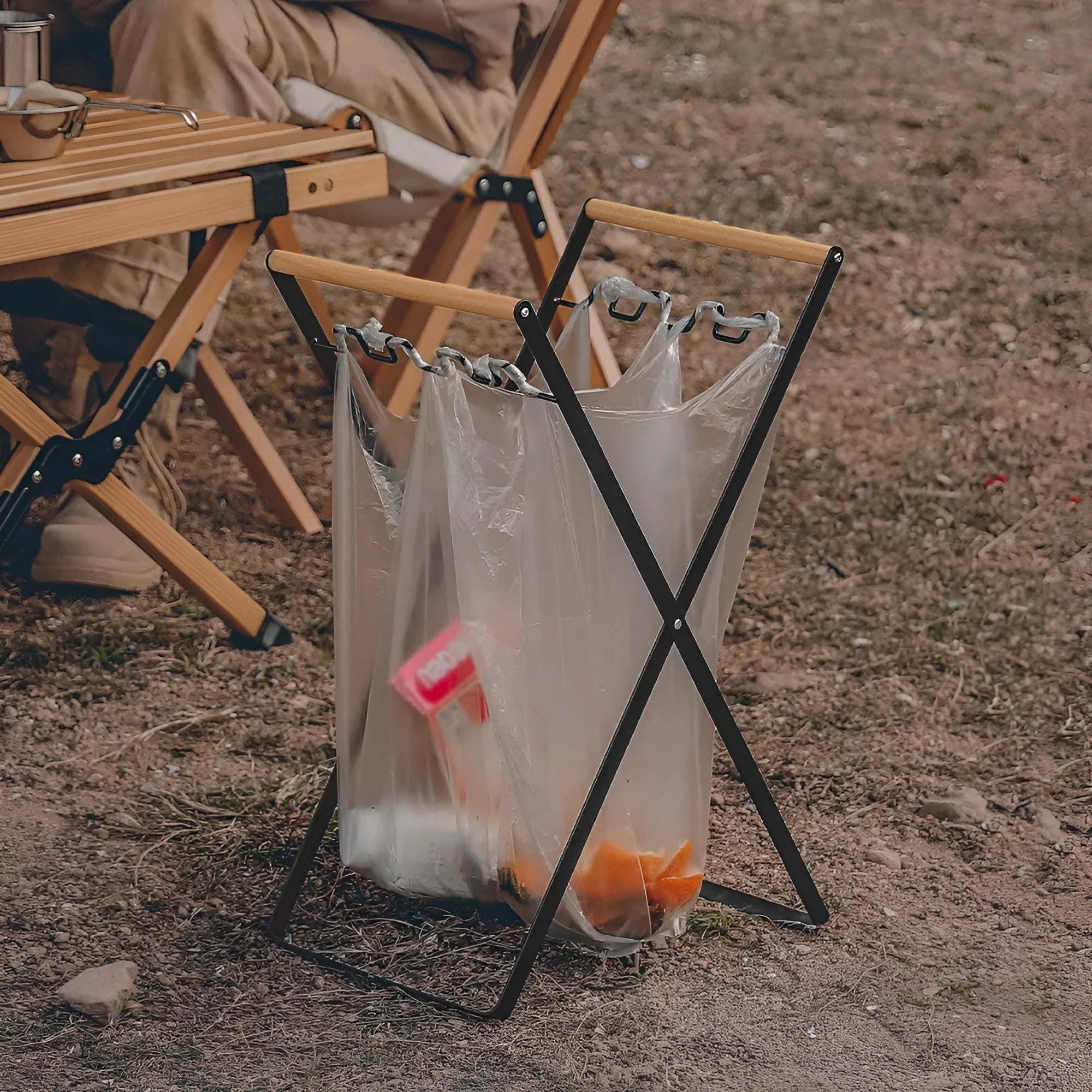 Folding outdoor rubbish rack with iron frame and wooden handle, shown in black colour.