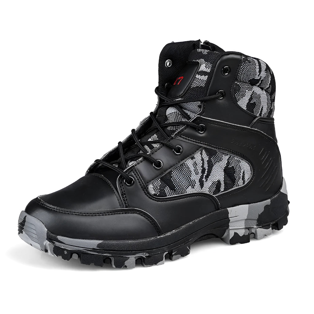 Men's black high-top hiking shoe with metal detail on a rugged outdoor surface
