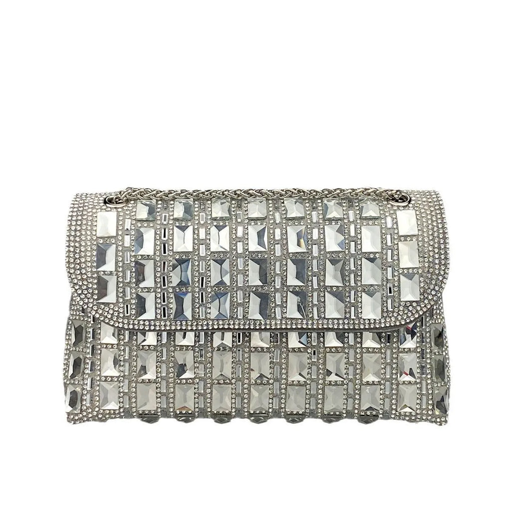 Silver rhinestone chain clutch bag with square shape and internal phone pocket on a table.