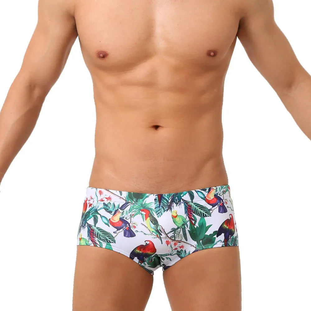 Men's swimming trunks with flower-bird print pattern in nylon fabric showing briefs style