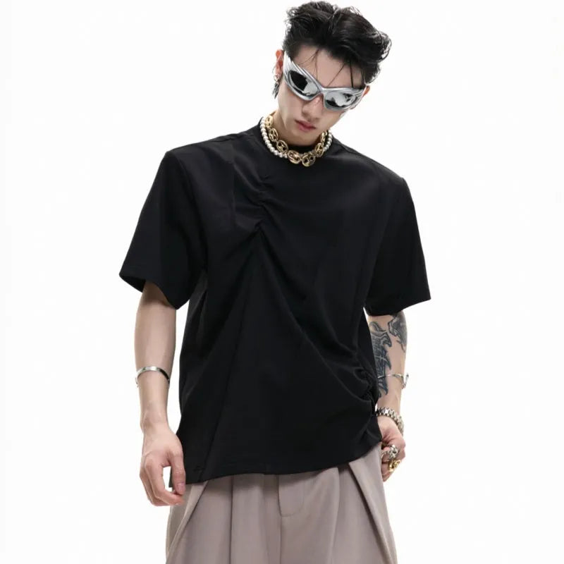 Men's black cotton t-shirt with three-dimensional pleats and a round neck, laid flat.