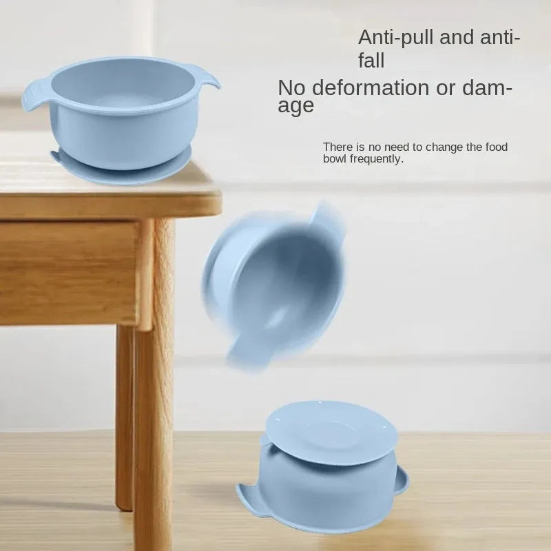 Blue silicone pet bowl with a white suction cup base on a kitchen floor.
