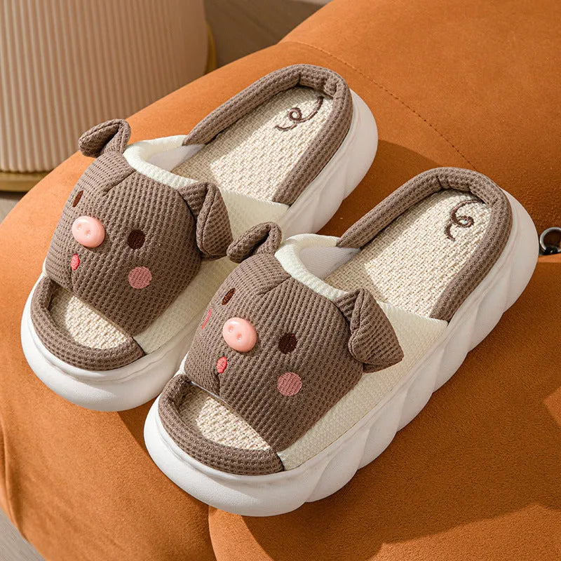 Pair of open-toe linen flip-flop slippers for couples on a plain background, showing colours and strap detail.