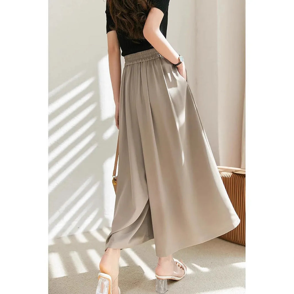Wide-leg women's trousers in milk apricot with stacked hem design and pockets, flat lay view