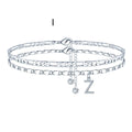 Silver-toned copper anklet with double-circle charm and bead, showing letter styling option