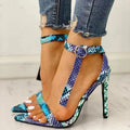 Blue women's high heels with buckle fastening and hollow out design on a pointed toe.