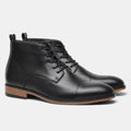 Men's brown Chelsea boot with side zipper, round toe, low heel, and wooden sole.