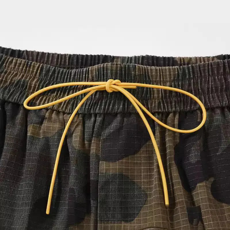 Men's green washed camouflage cotton workwear shorts with a loose fit on a mid-waist.