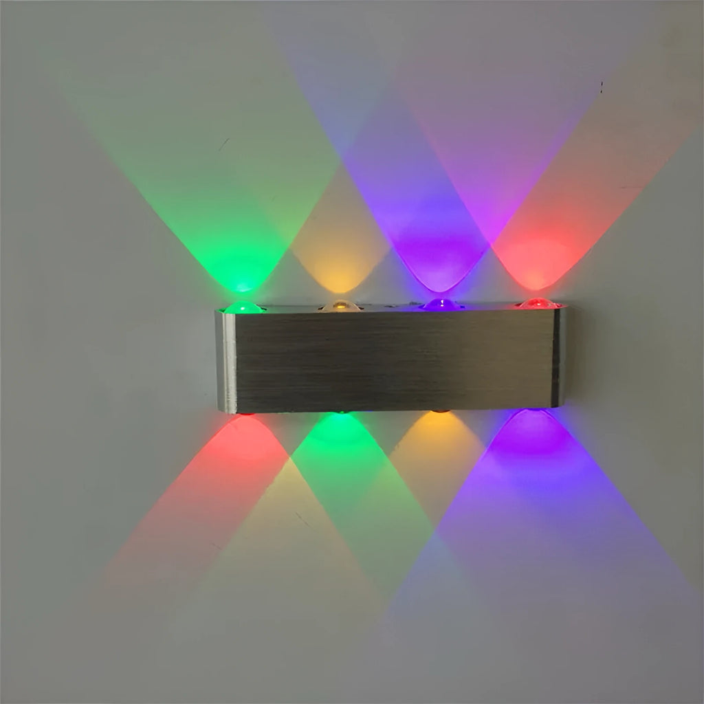 Silver aluminium rectangular LED wall lamp mounted on a wall, displaying multiple light colour options.