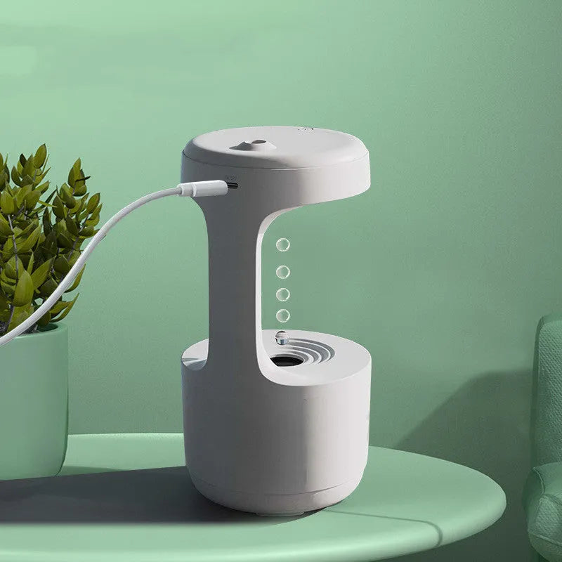 White columnar anti-gravity humidifier with LED clock display and water droplet backflow feature