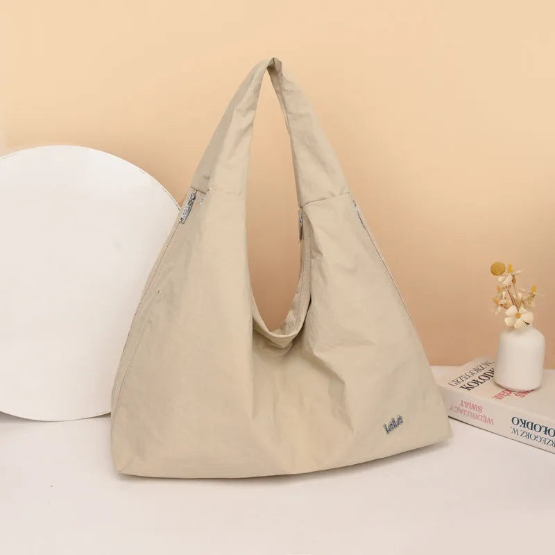 Women's heart-shaped nylon underarm bag in black, yellow, khaki, or blue colours showing large capacity design