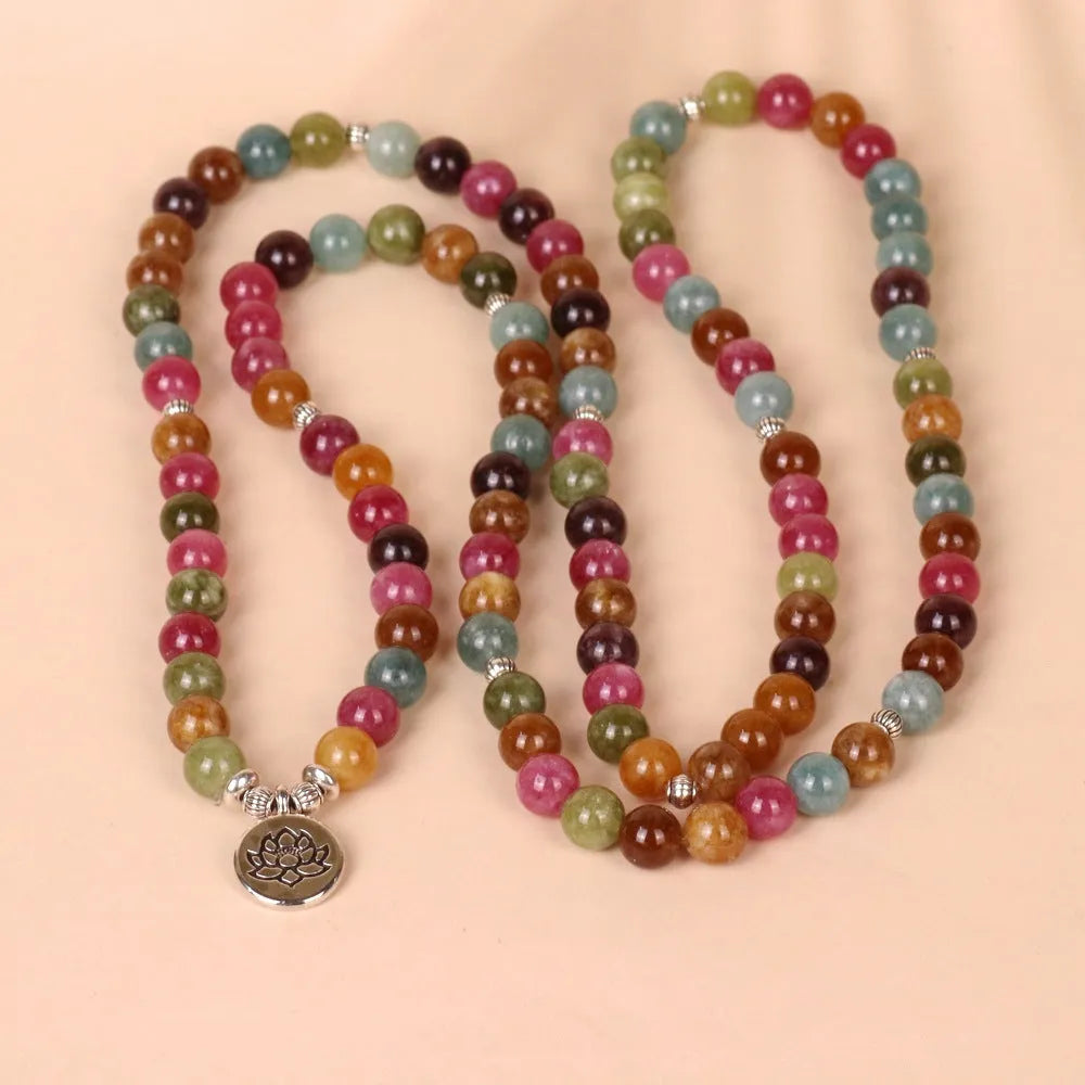 Tourmaline-colour alloy bracelet with 108 beads in a lotus string design laid flat