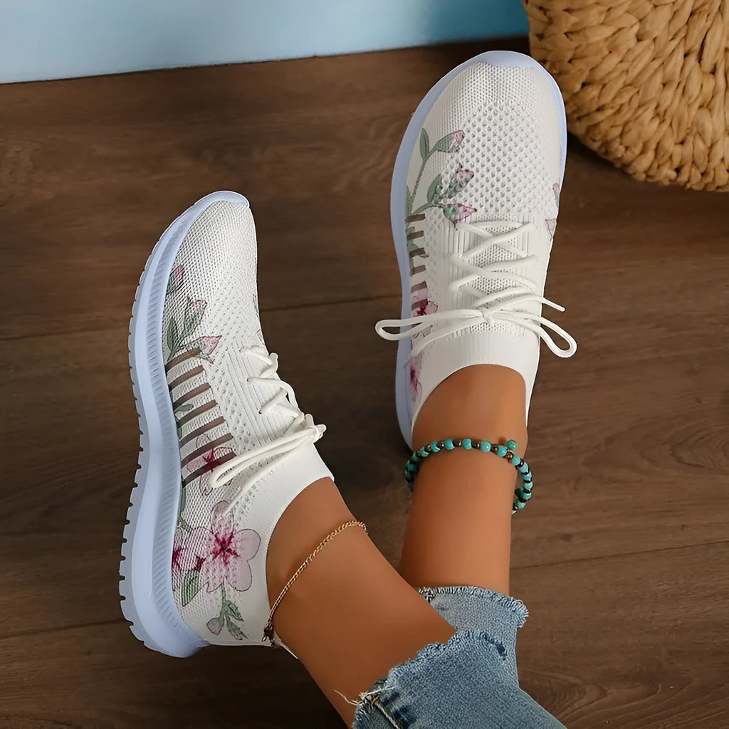 Women's Milky White mesh flyknit running shoes with round toe and rubber sole on a flat surface.