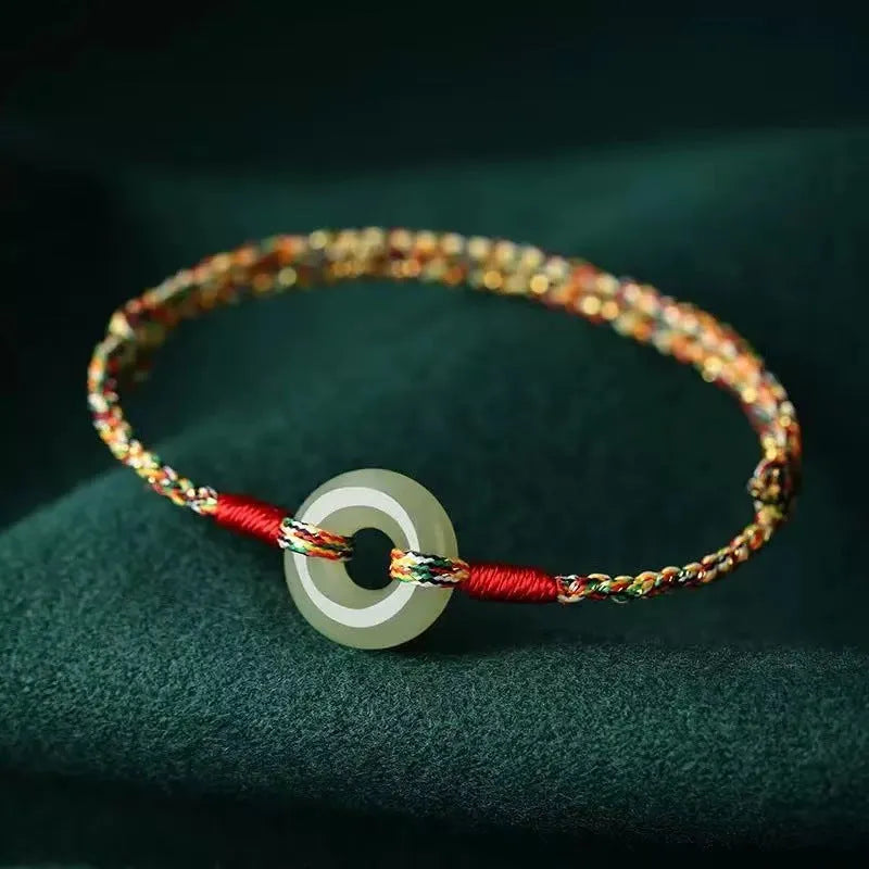 Colourful woven rope bracelet with peace buckle closure on wrist