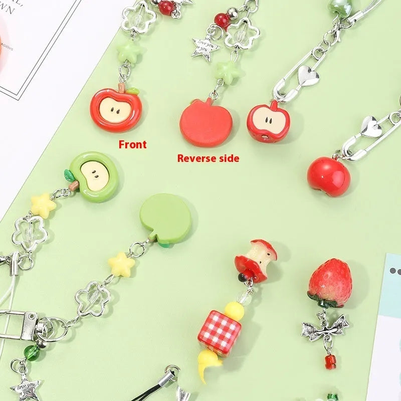 Mobile phone charm keychain with fruit designs including apple and strawberry patterns