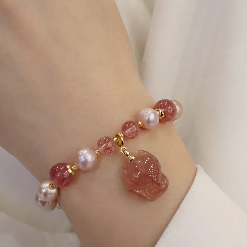 Light pink women's freshwater pearl bracelet with strawberry quartz stones and fox charm