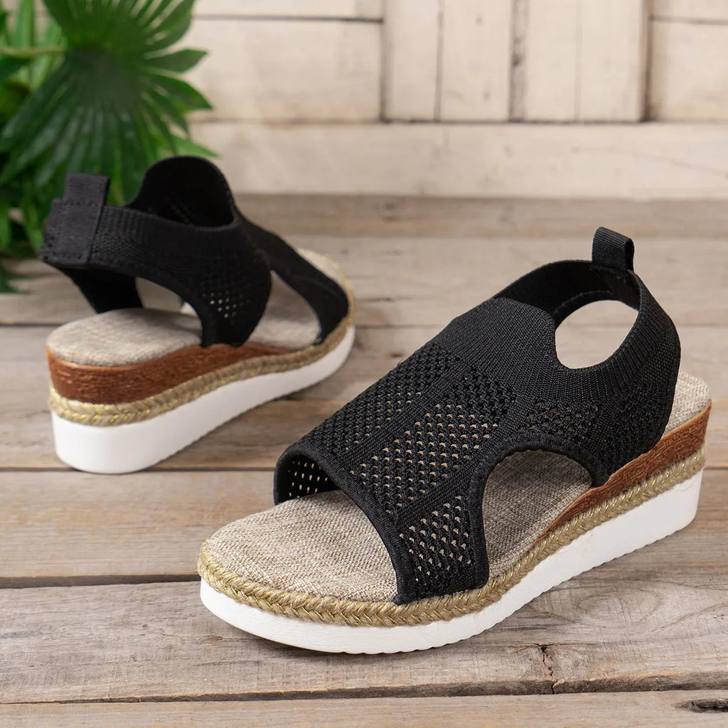 Women's hollow wedge peep-toe sandals in beige with patent leather upper and breathable mesh, side view
