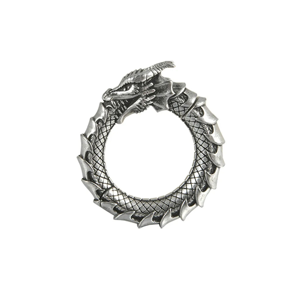 A pair of large antique silver hoop earrings with a hollow-out geometric dragon shape design.