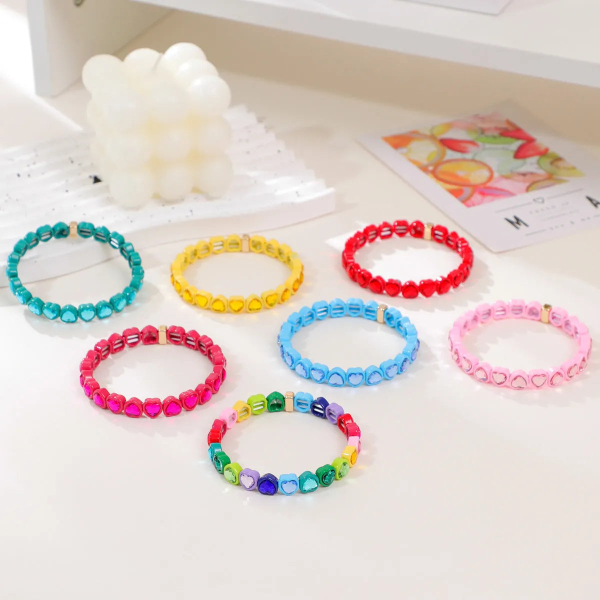 Rainbow coloured alloy heart charm on a stretch bracelet with a diamond-effect finish.