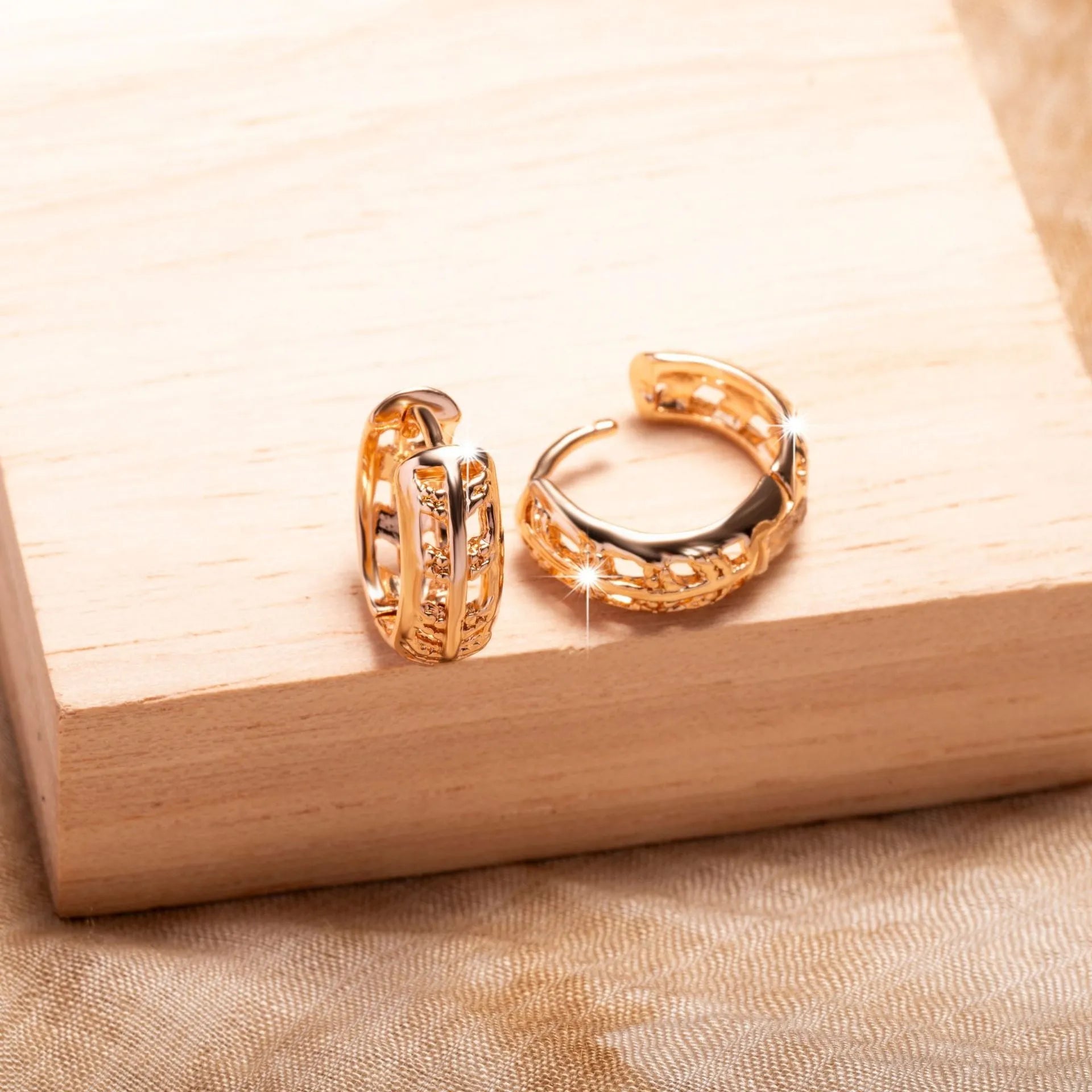 Small copper earrings with hollowed-out leaf and heart shapes, rose gold plated.