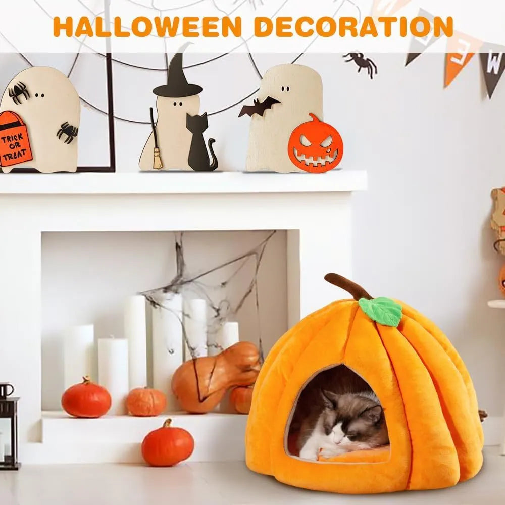 Orange pumpkin-shaped cat cave bed with plush entry hole on a wooden floor