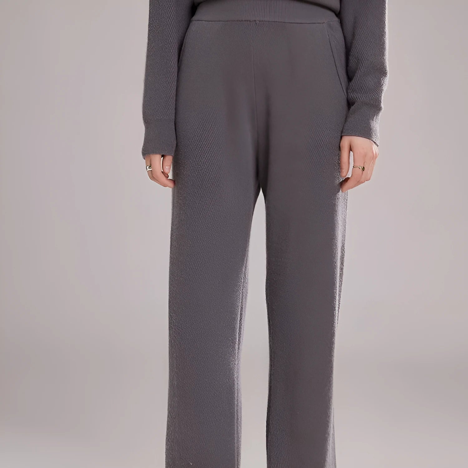 Women's thick cashmere leggings in green velvet colour, showing high elasticity and stitching detail.