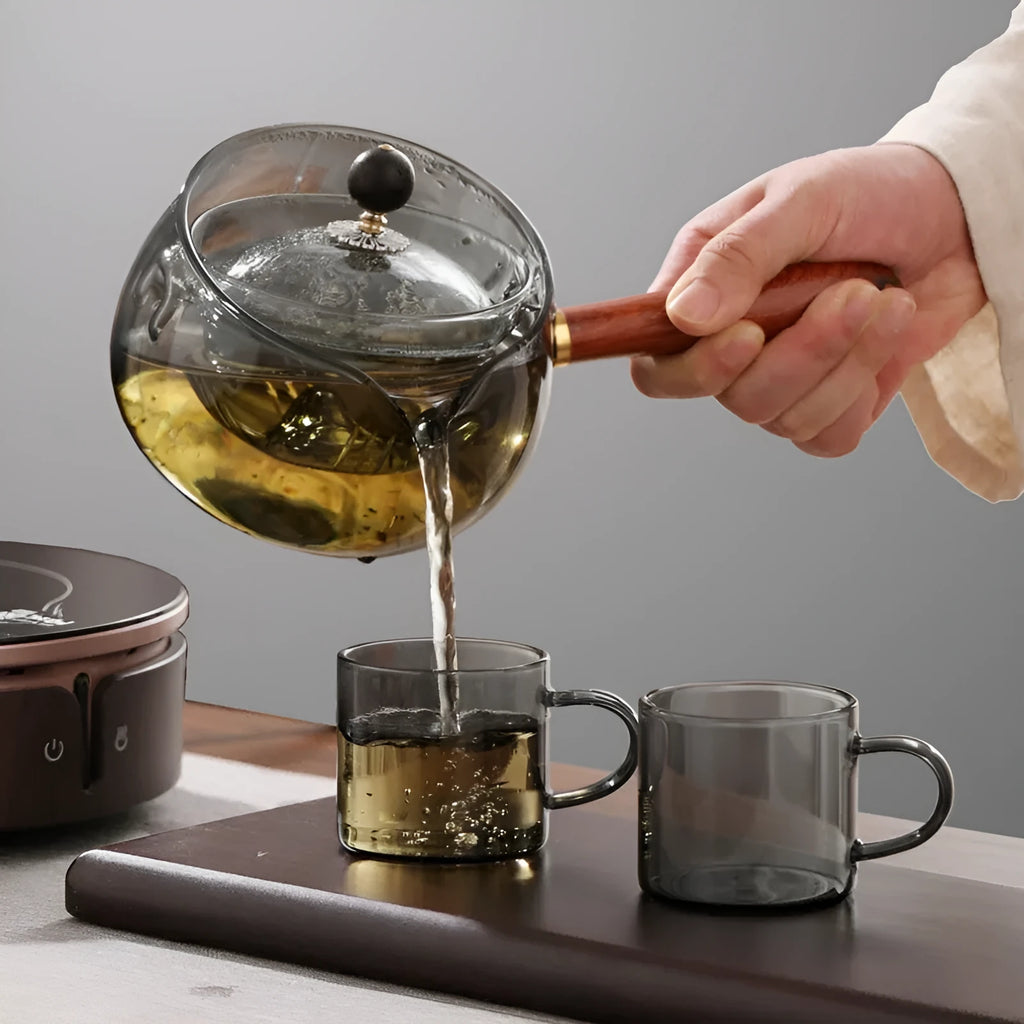 Semi-automatic rotary glass teapot with wooden handle and infuser, in grey and transparent colour options.