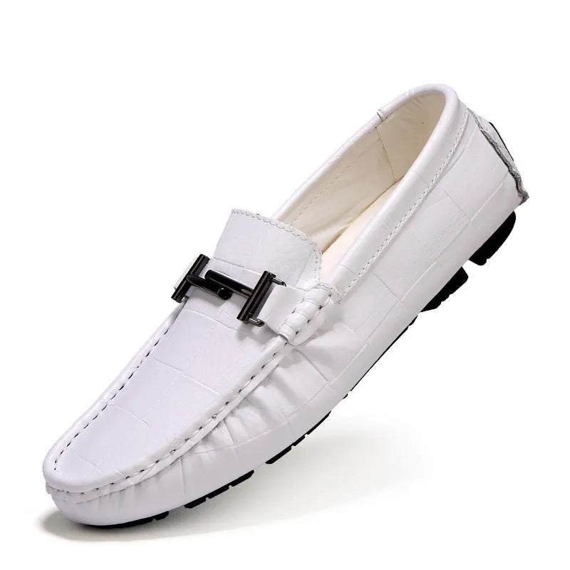 Men's black leather casual shoes with a silver belt buckle detail on the low-cut upper.