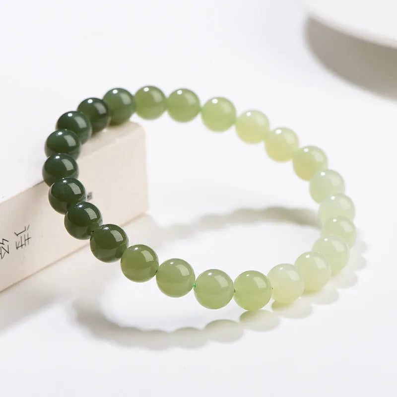 Natural clear water Hetian jade ball bracelet showing gradient jade beads in round or barrel shapes