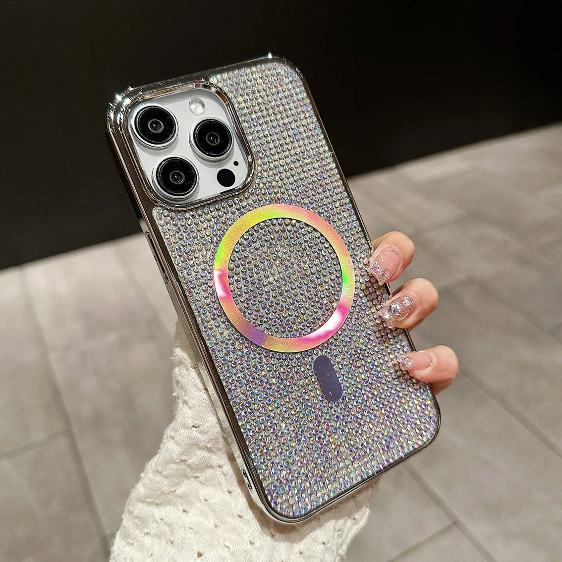 Rhinestone electroplating TPU phone case with diamond magnetic suction on a black iPhone model