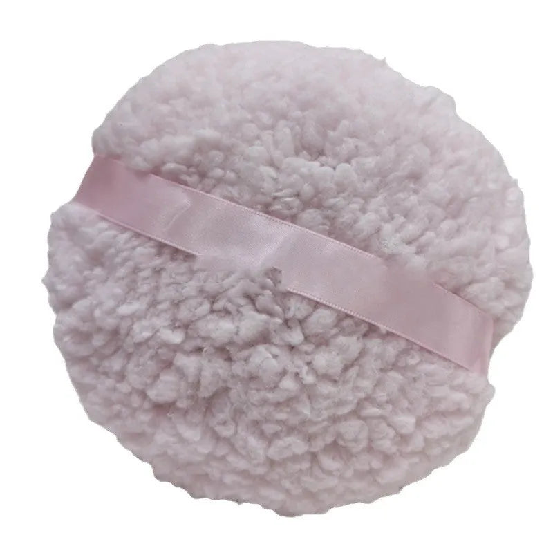Oversized rectangular plush powder puff in pink on a white background.