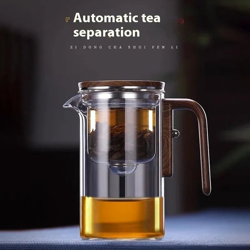 Glass teapot with wooden handle showing magnetic separation button and inner filter basket.