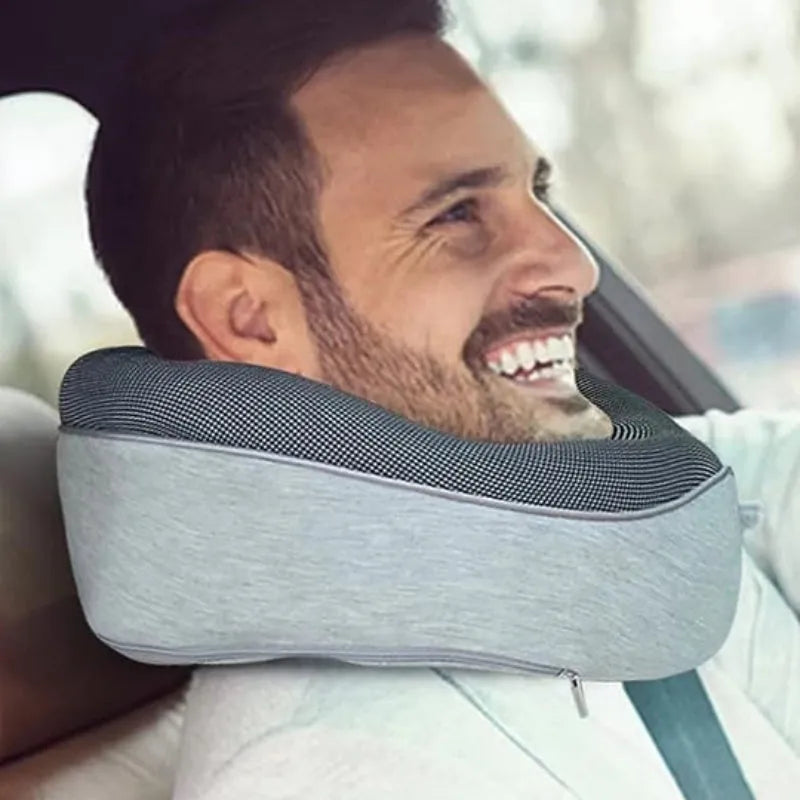 Navy blue U-shaped travel neck pillow with memory foam, shown rolled up next to its carry bag.