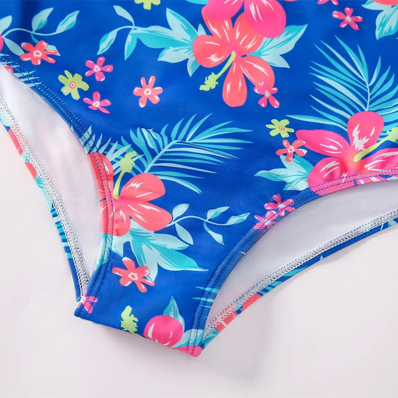 Girl's long-sleeve one-piece swimming suit in polyester fabric on a mannequin, showing briefs style.