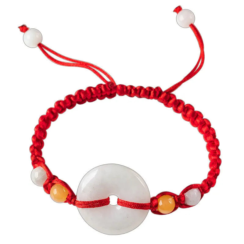 Round emerald jade pendant on adjustable red cord bracelet