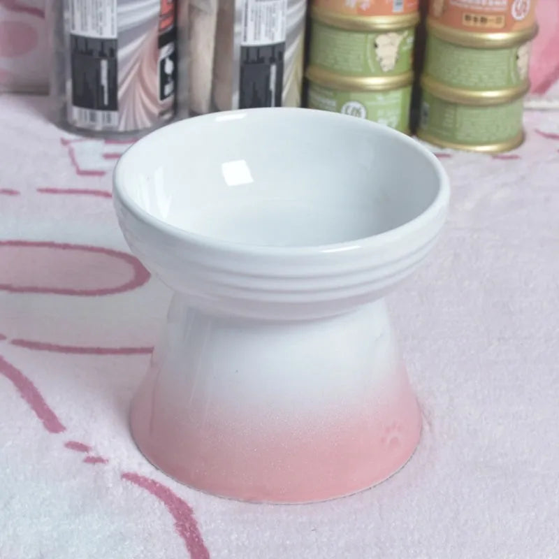 High-foot ceramic pet bowl with black chin area for spill prevention, shown on a table.
